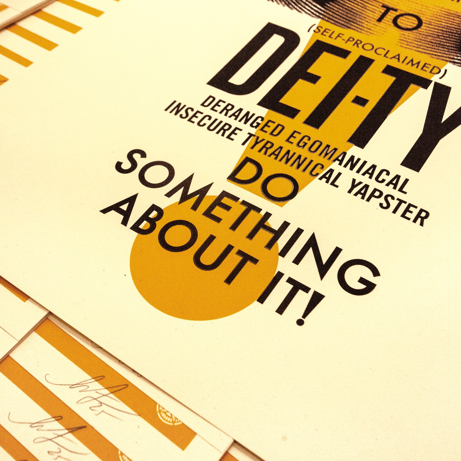 A close-up of the bottom right of a poster with text: DEITY DERANGED EGOMANIACAL INSECURE TYRANNICAL YAPSTER DO SOMETHING…