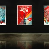 A modern art gallery with a black wall displaying three framed art prints. The left and right prints feature circular…