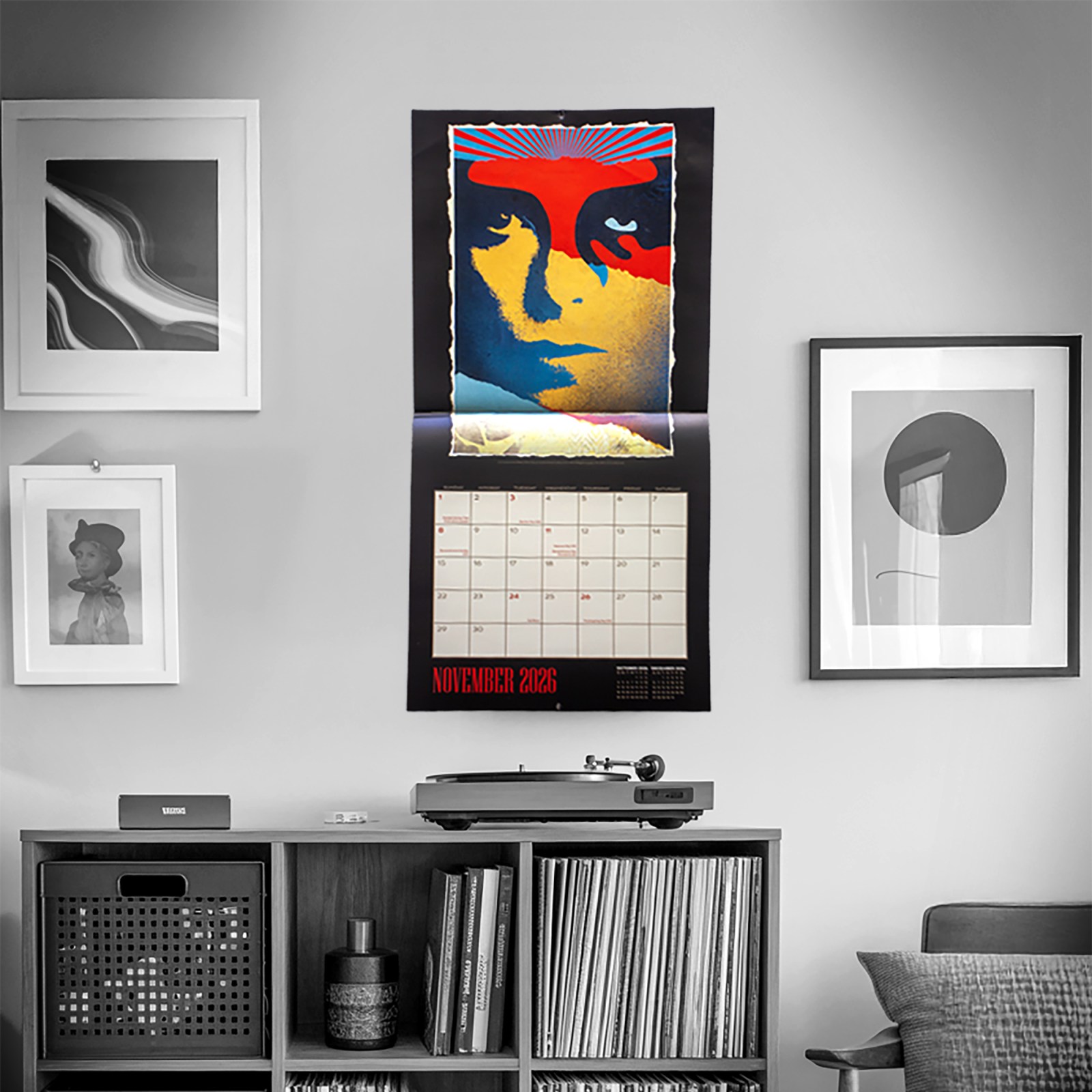 2026 November calendar featuring stylized portrait; record player and vinyl collection below.