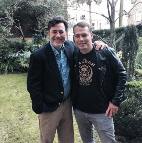 Stephen Colbert and a man in a The Asbah San Diego t-shirt.