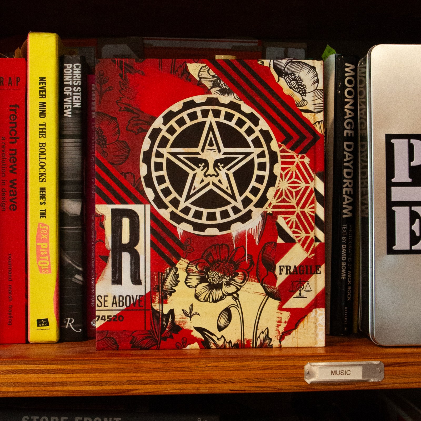 A red book with a black star design and floral patterns, titled